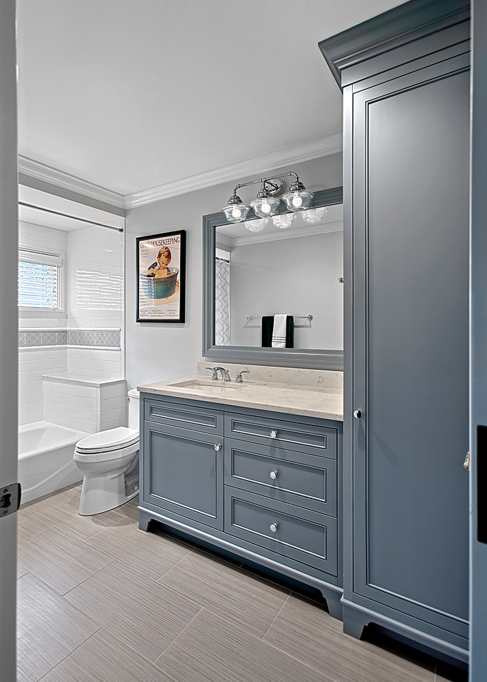 Alcove bathtub - mid-sized transitional gray tile porcelain tile, gray floor and single-sink alcove bathtub idea in Chicago with recessed-panel cabinets, gray cabinets, quartz countertops, a two-piece toilet, gray walls, an undermount sink, white countertops and a built-in vanity
