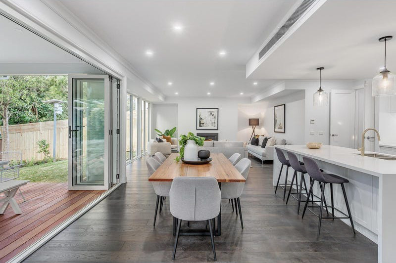 Inspiration for a large modern open plan dining in Melbourne with white walls, dark hardwood floors, a standard fireplace, a plaster fireplace surround and recessed.