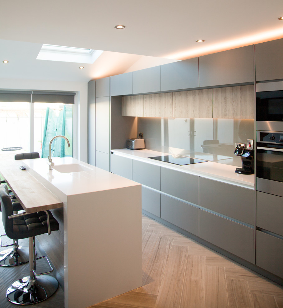 Design ideas for a contemporary open plan kitchen in Dublin with quartzite benchtops, porcelain floors, with island and beige floor.
