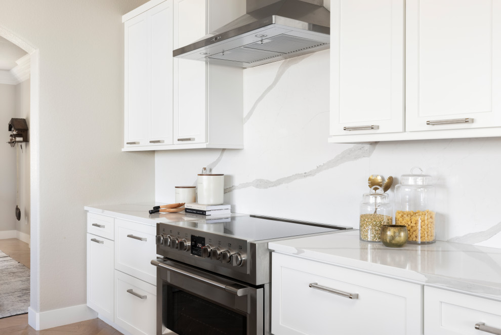 Inspiration for a large transitional l-shaped light wood floor enclosed kitchen remodel in Denver with a double-bowl sink, shaker cabinets, gray cabinets, quartz countertops, white backsplash, quartz backsplash, stainless steel appliances, two islands and white countertops