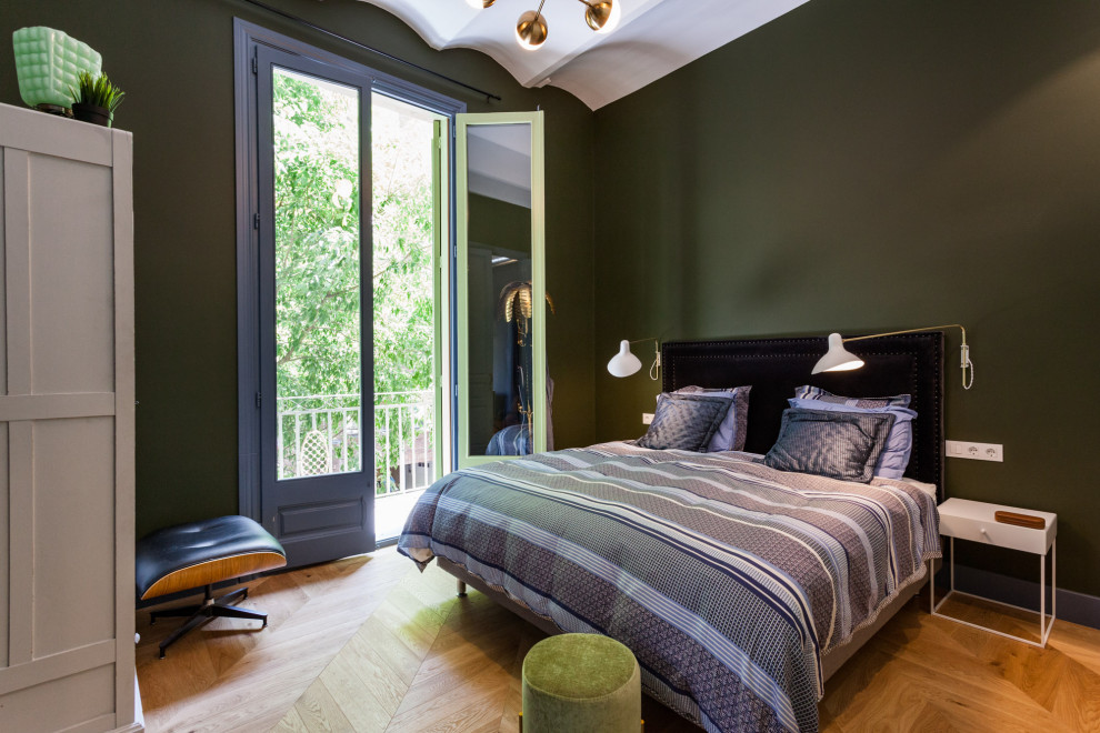 Mediterranean bedroom in Other with green walls and medium hardwood floors.