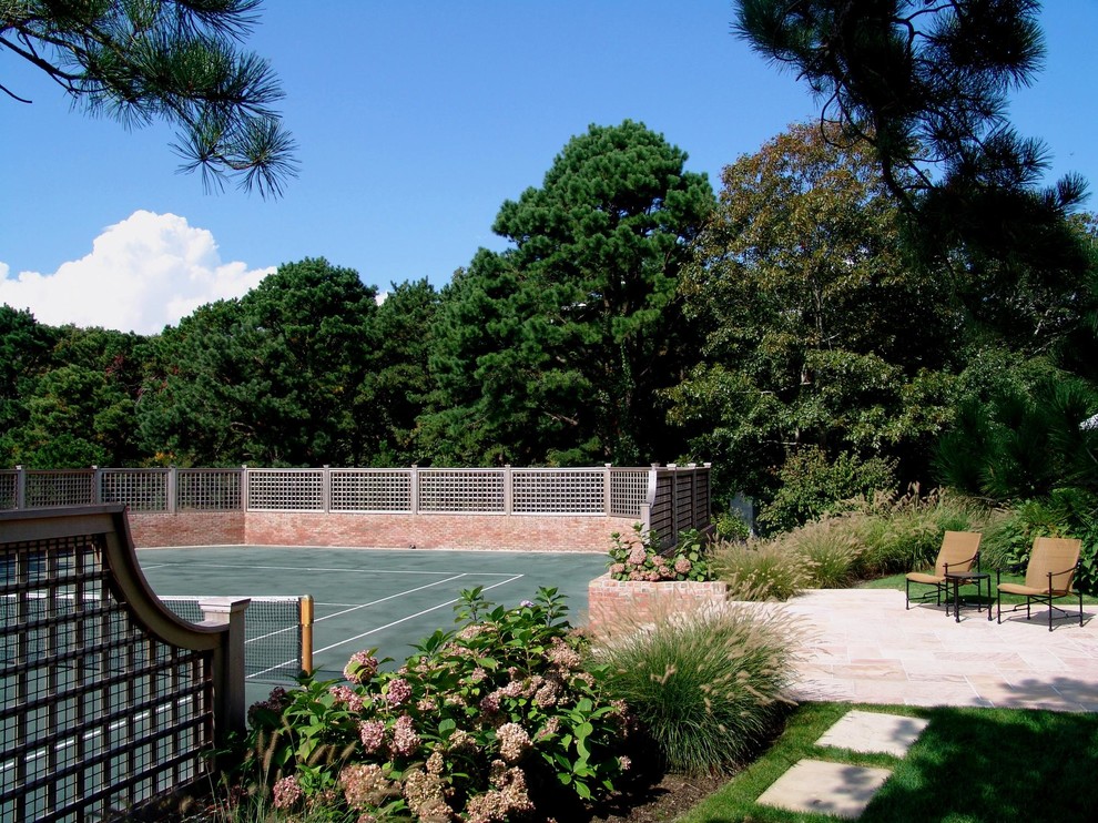 This is an example of a large traditional backyard partial sun outdoor sport court in New York with concrete pavers and with outdoor playset.