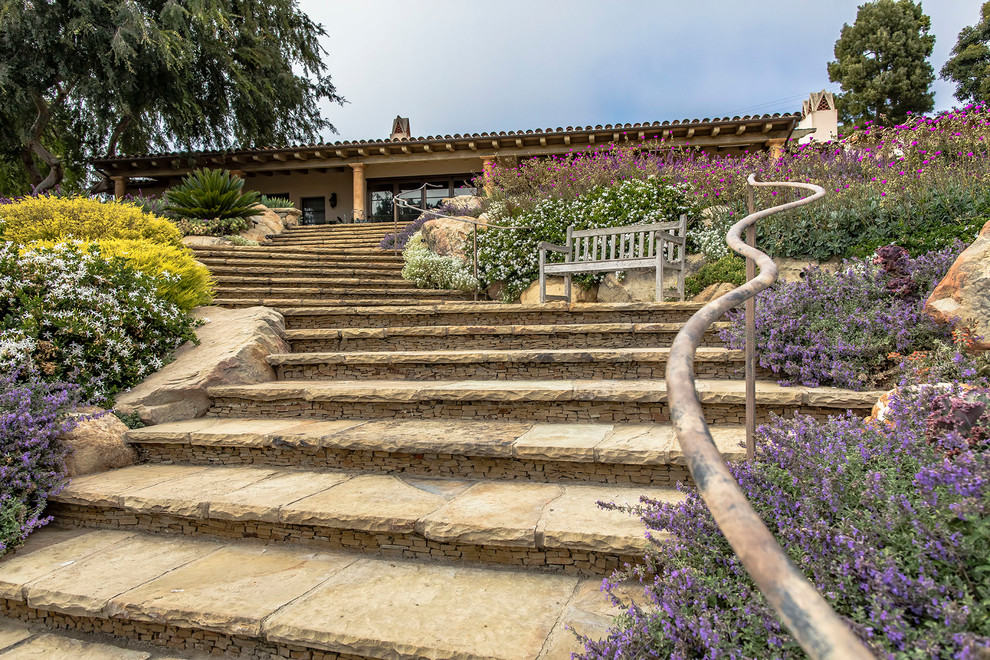 Design ideas for a mediterranean backyard garden in Santa Barbara with natural stone pavers.