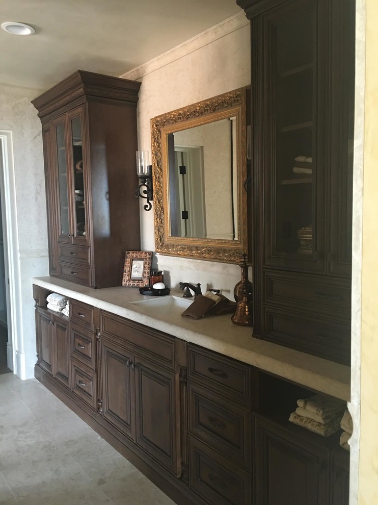 Inspiration for a large traditional master bathroom in Orange County with raised-panel cabinets, dark wood cabinets, multi-coloured tile, mosaic tile, beige walls, mosaic tile floors, an undermount sink, granite benchtops, a corner tub and an alcove shower.