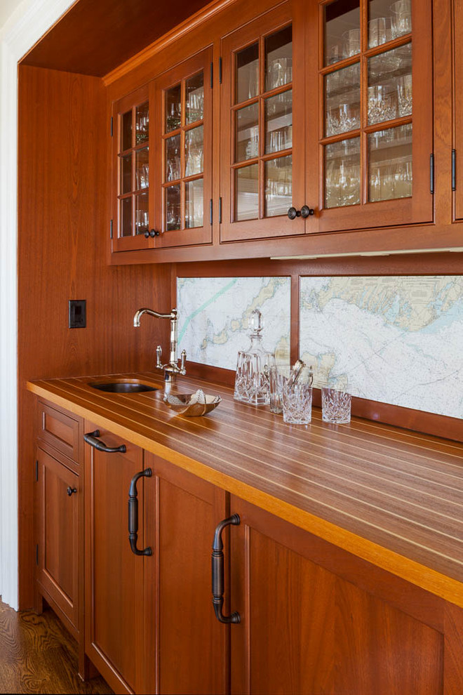 Design ideas for a mid-sized traditional single-wall wet bar in Boston with an undermount sink, medium wood cabinets, wood benchtops, multi-coloured splashback, ceramic splashback, medium hardwood floors and brown benchtop.