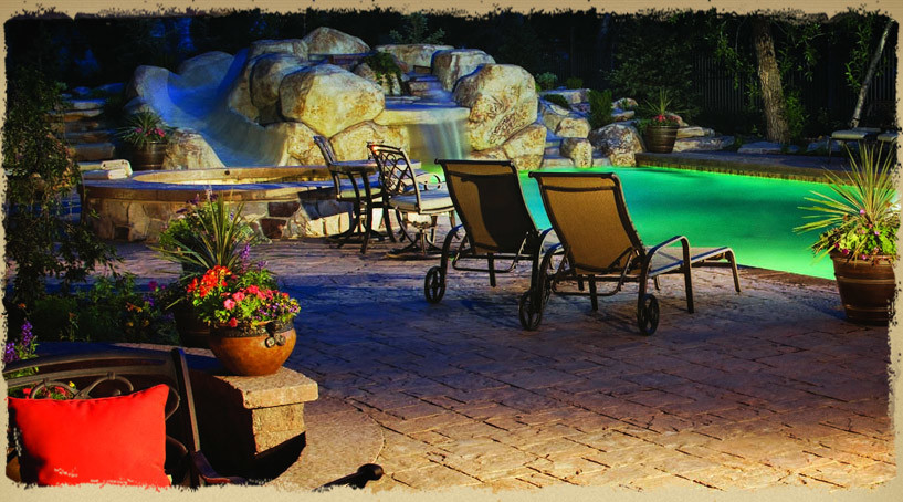 Example of a mid-sized mountain style backyard concrete paver and rectangular lap hot tub design
