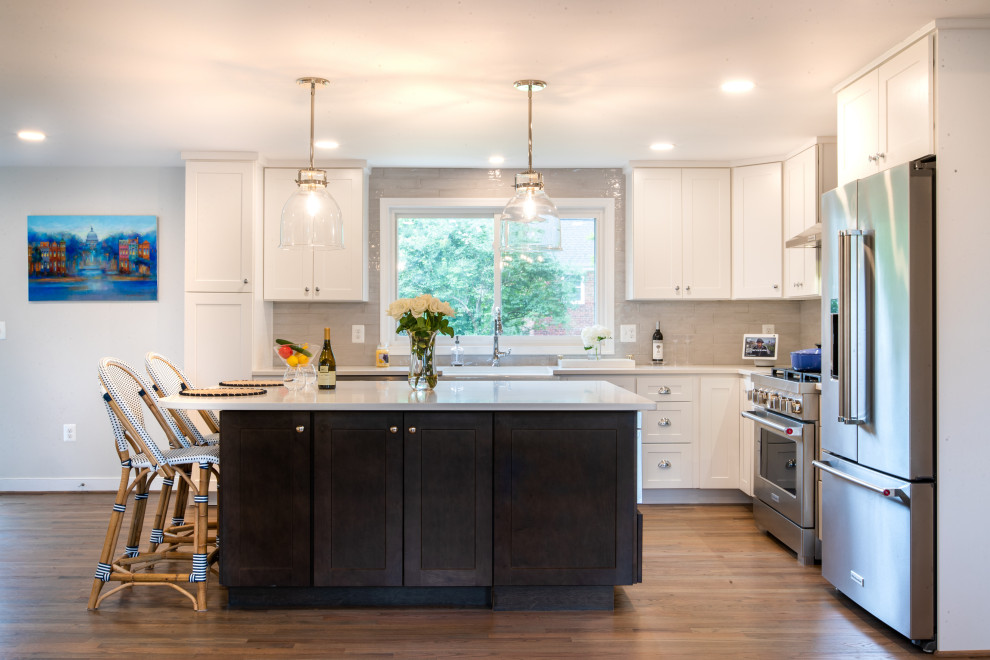 Mid-sized scandinavian galley eat-in kitchen in DC Metro with a farmhouse sink, recessed-panel cabinets, white cabinets, quartzite benchtops, white splashback, subway tile splashback, stainless steel appliances, light hardwood floors, with island, beige floor and white benchtop.