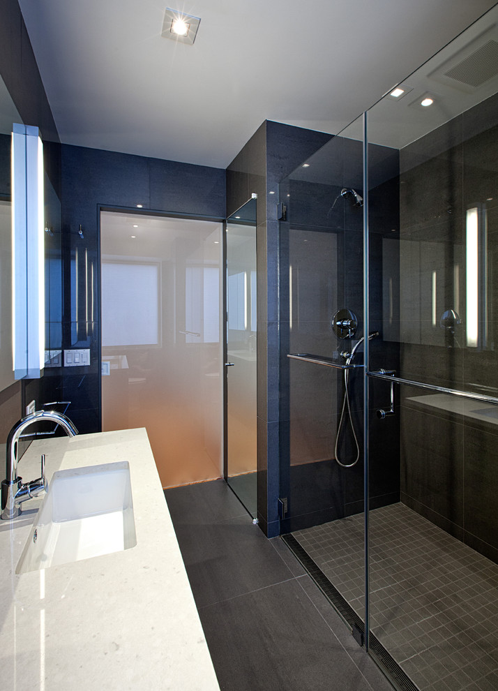 Contemporary bathroom in New York with an undermount sink, a curbless shower, gray tile and ceramic tile.