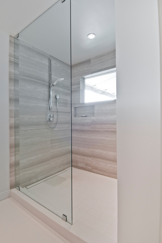 Photo of a large modern master bathroom in Los Angeles with flat-panel cabinets, brown cabinets, an open shower, gray tile, limestone, white walls, porcelain floors, an undermount sink, beige floor and an open shower.