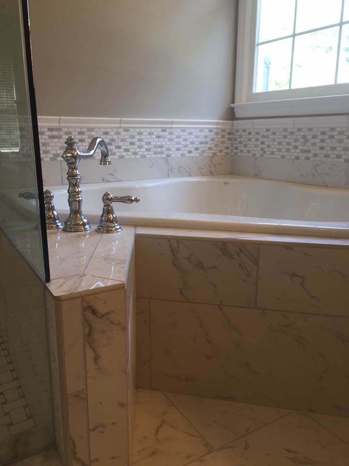 Photo of a mid-sized traditional master bathroom in Charlotte with recessed-panel cabinets, white cabinets, a corner tub, a corner shower, white tile, porcelain tile, grey walls, porcelain floors, an undermount sink, quartzite benchtops, white floor, a hinged shower door and a two-piece toilet.
