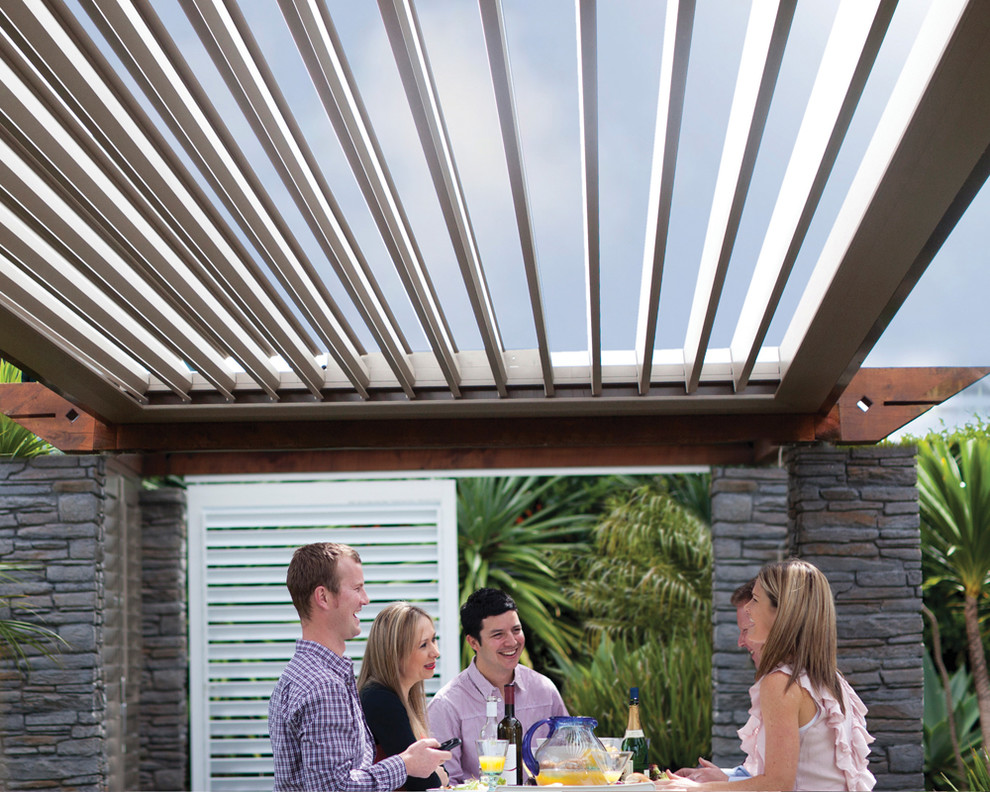 Inspiration for a contemporary backyard patio in Other with a roof extension.