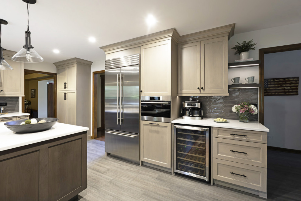 Inspiration for a large transitional porcelain tile and gray floor eat-in kitchen remodel in Chicago with a farmhouse sink, recessed-panel cabinets, light wood cabinets, quartz countertops, gray backsplash, porcelain backsplash, an island and white countertops