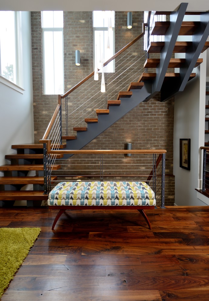 Inspiration for an expansive industrial wood floating staircase in Raleigh with open risers and cable railing.