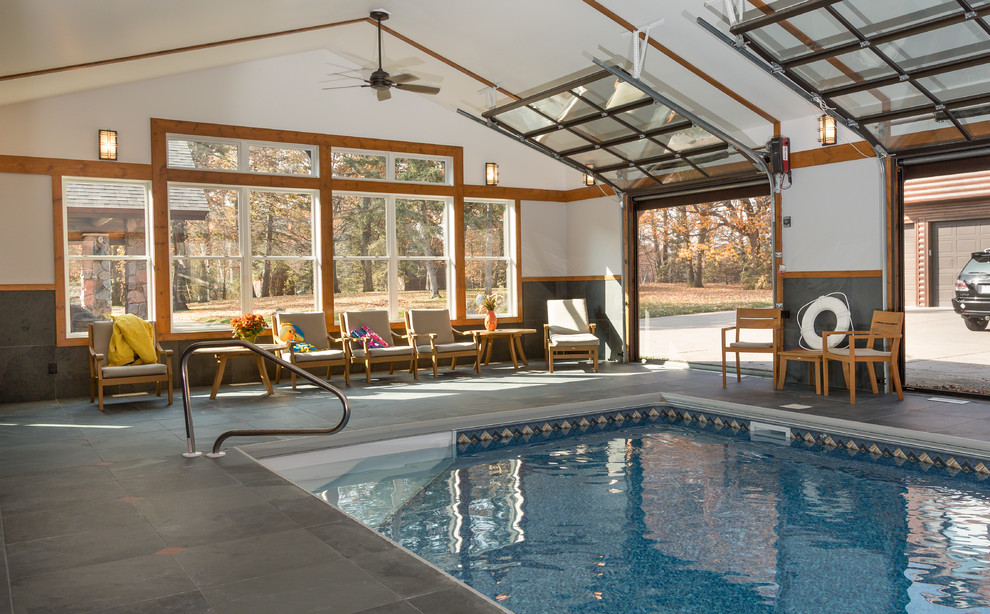 Inspiration for a large country indoor rectangular pool in Minneapolis with a pool house and tile.