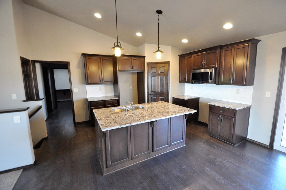 Inspiration for a large medium tone wood floor open concept kitchen remodel with an island