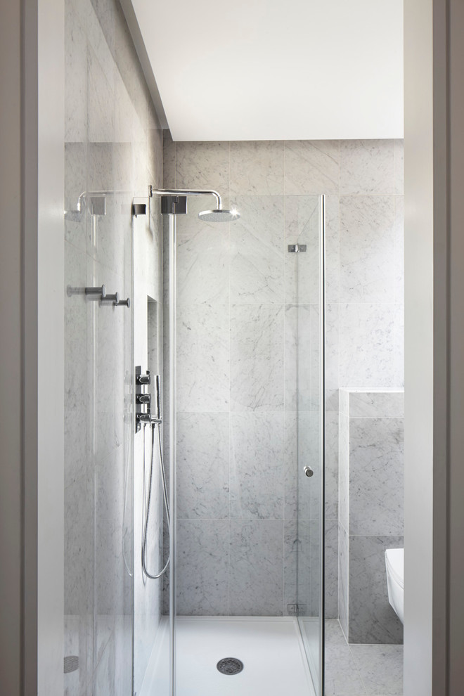 Inspiration for a small contemporary master white tile and porcelain tile marble floor walk-in shower remodel in London with flat-panel cabinets, white cabinets, a wall-mount toilet, white walls, a console sink and marble countertops