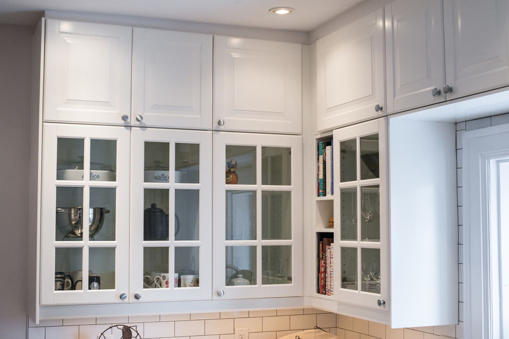 Home design - transitional galley home design idea in Ottawa with recessed-panel cabinets, black cabinets, quartzite countertops, white backsplash, stainless steel appliances and no island