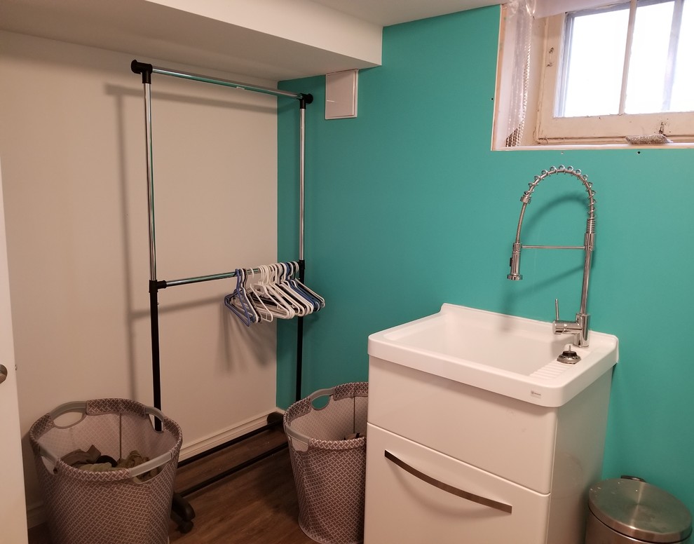 Design ideas for a laundry room in Toronto with vinyl floors, a side-by-side washer and dryer and brown floor.
