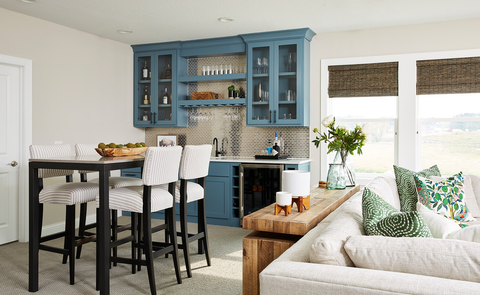 Inspiration for a transitional single-wall wet bar in Minneapolis with shaker cabinets, blue cabinets, grey splashback, metal splashback, carpet, grey floor and white benchtop.