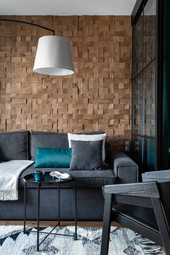 This is an example of a small scandinavian living room feature wall in Moscow with brown walls, medium hardwood flooring, brown floors and wainscoting.