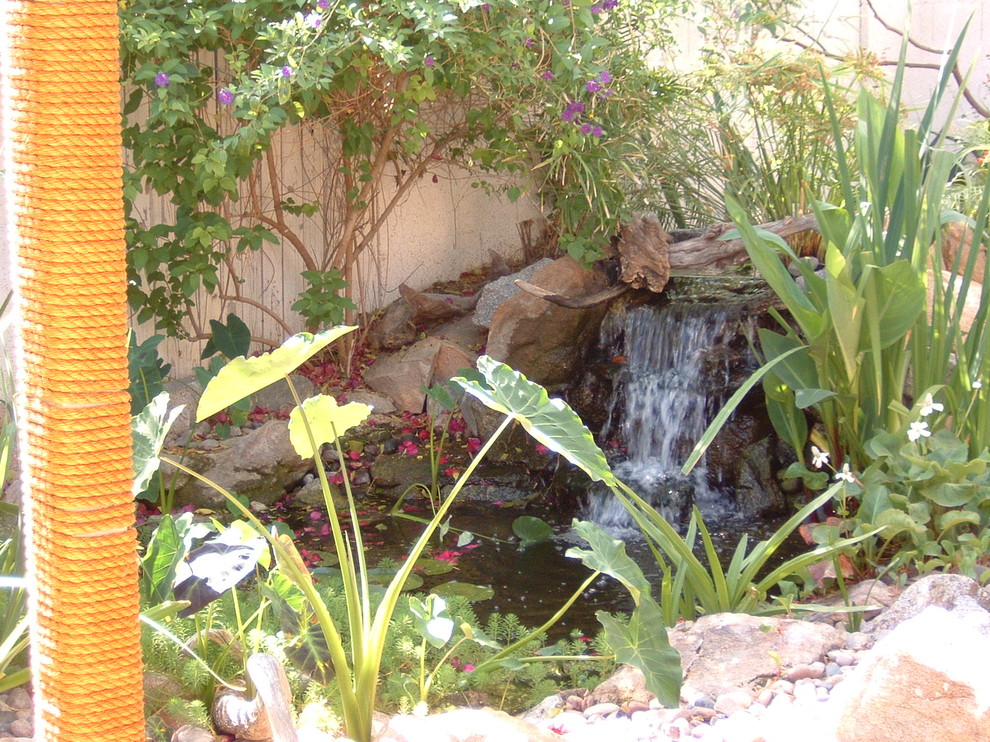 Small mediterranean backyard partial sun garden in Phoenix with with pond.