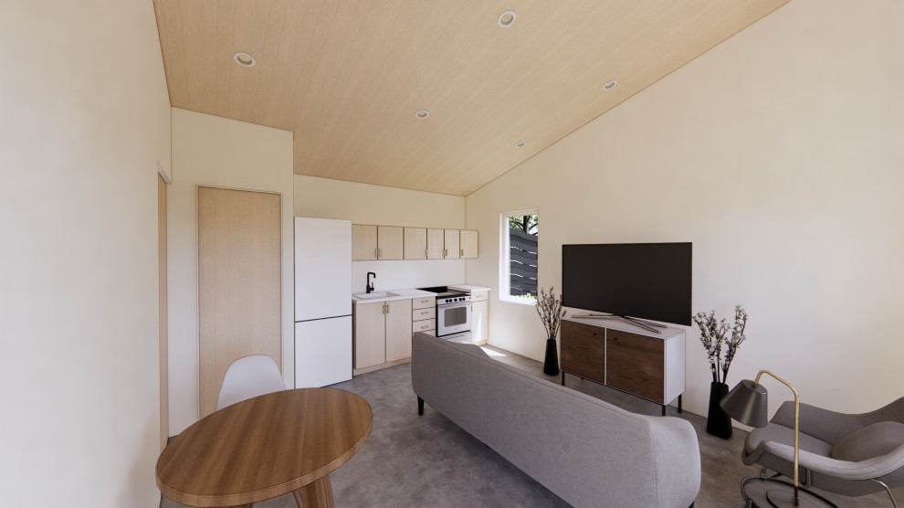 Bild på ett litet funkis allrum med öppen planlösning, med vita väggar, betonggolv, en fristående TV och grått golv
