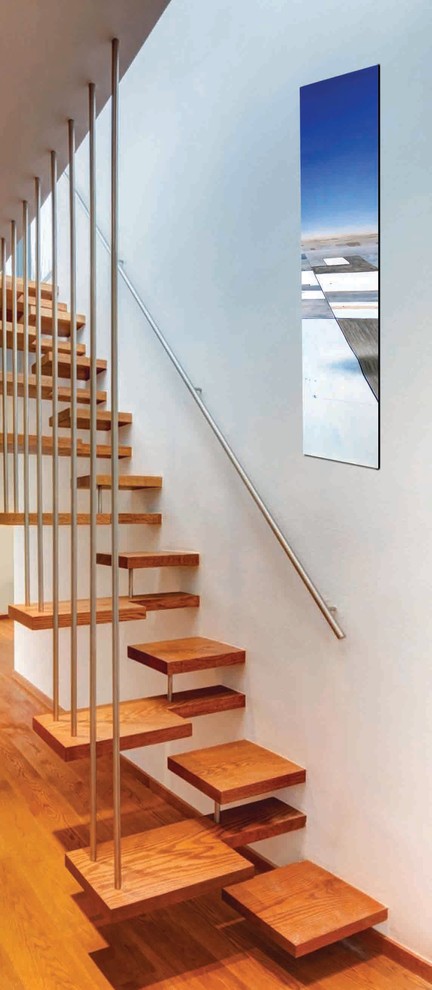Design ideas for a contemporary wood floating staircase in Oklahoma City with open risers and metal railing.