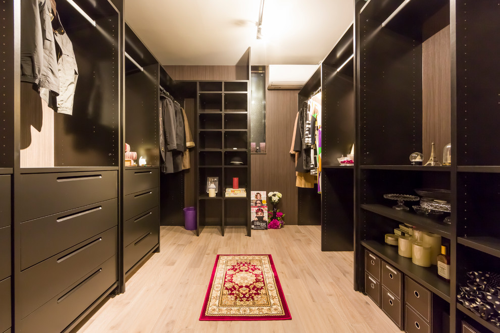 Midcentury walk-in wardrobe with painted wood floors and beige floor.