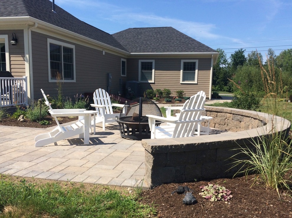 Mid-sized contemporary backyard patio in Portland Maine with concrete pavers, a fire feature and no cover.