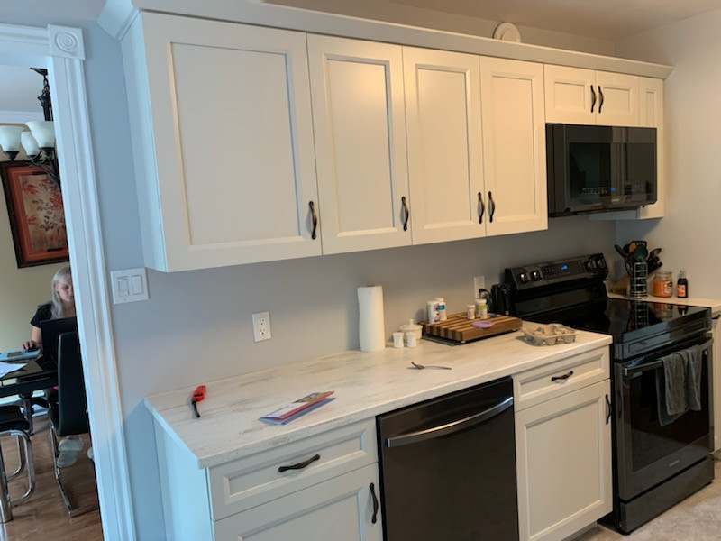 Photo of a medium sized traditional galley enclosed kitchen in Other with a built-in sink, grey cabinets, composite countertops, white appliances, no island, white worktops and recessed-panel cabinets.