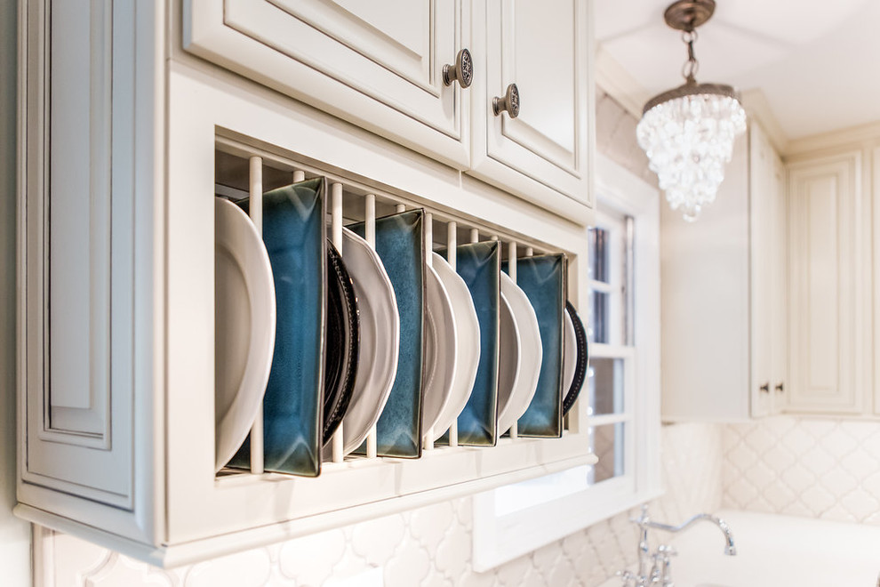 Large l-shaped medium tone wood floor open concept kitchen photo in Birmingham with a farmhouse sink, raised-panel cabinets, white cabinets, granite countertops, white backsplash, ceramic backsplash, stainless steel appliances and an island