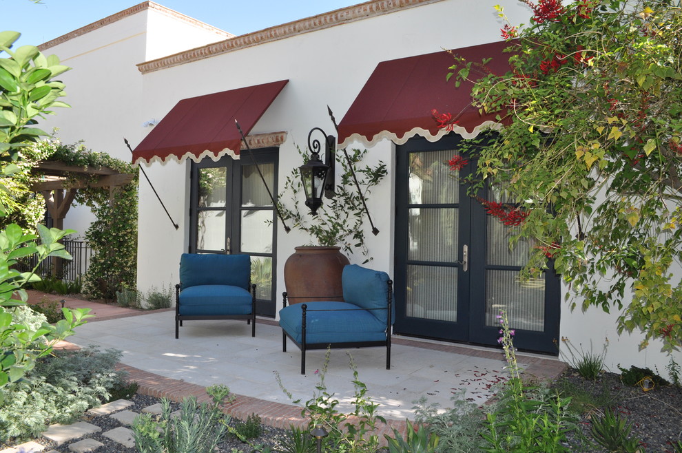 This is an example of a mediterranean patio in Phoenix with no cover.