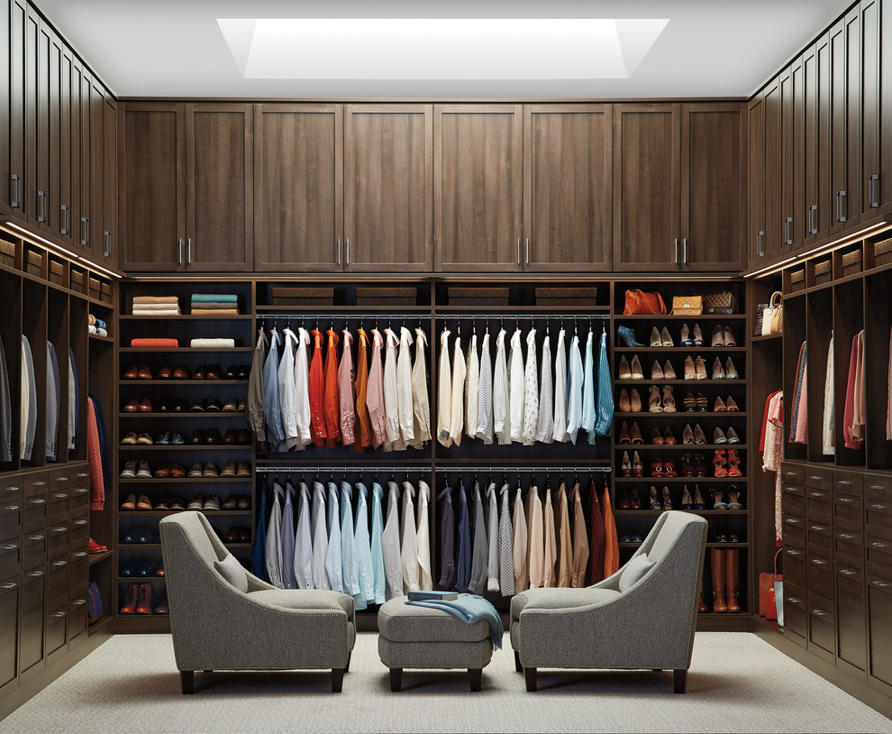 Inspiration for a transitional gender-neutral carpeted dressing room remodel with shaker cabinets and dark wood cabinets