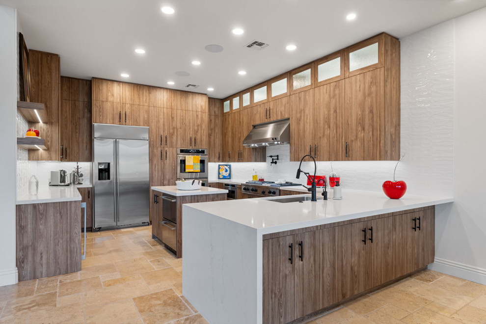 Inspiration for a rustic l-shaped slate floor and beige floor enclosed kitchen remodel with a single-bowl sink, flat-panel cabinets, medium tone wood cabinets, quartzite countertops, white backsplash, glass sheet backsplash, stainless steel appliances, a peninsula and white countertops