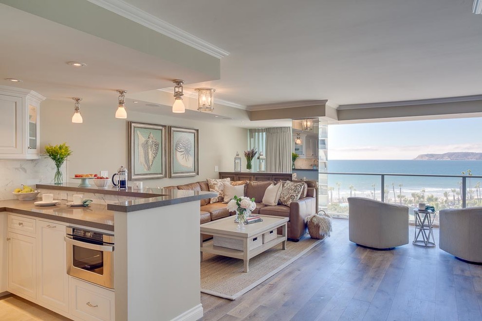 Photo of a small beach style living room in San Diego with beige walls and medium hardwood floors.