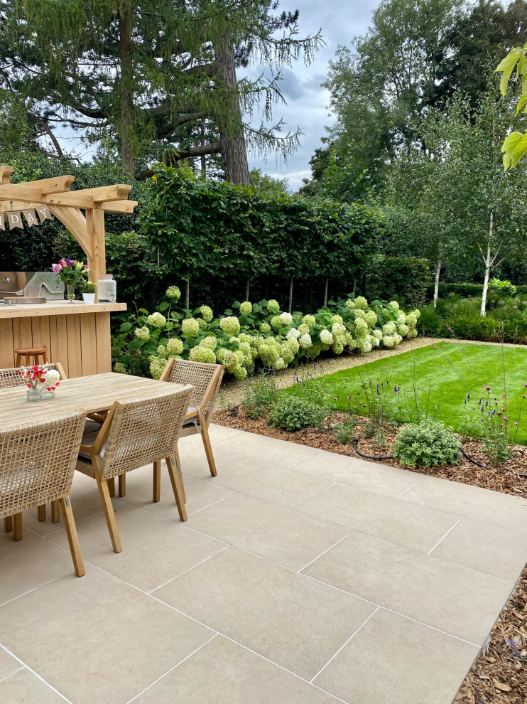 This is an example of a contemporary patio in Surrey.