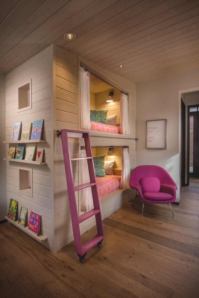 Photo of a country kids' room for girls in Boise with grey walls and medium hardwood floors.
