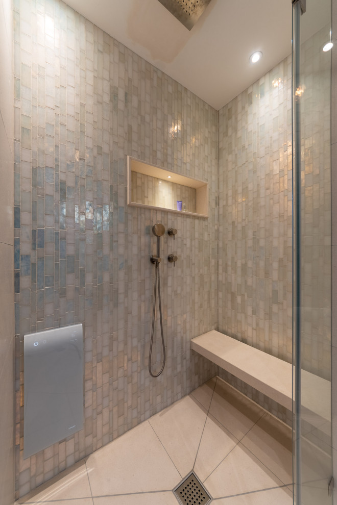 This is an example of a mid-sized contemporary 3/4 bathroom in Munich with glass-front cabinets, brown cabinets, a drop-in tub, a corner shower, a one-piece toilet, beige tile, mosaic tile, beige walls, ceramic floors, a vessel sink, beige floor, a sliding shower screen, white benchtops, a shower seat, a double vanity and a freestanding vanity.
