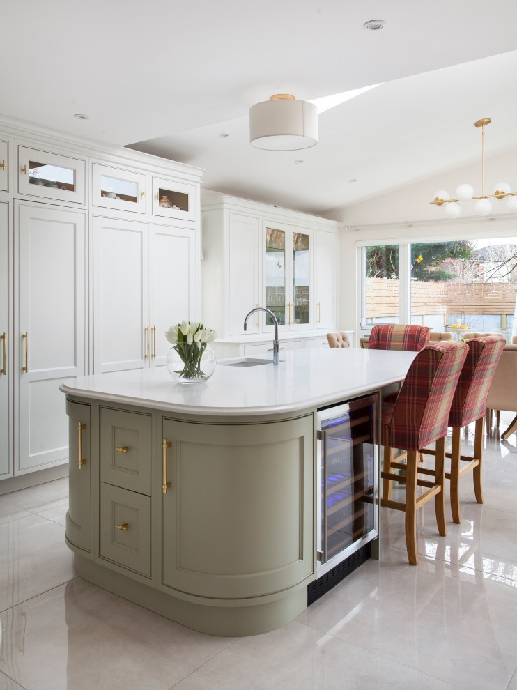 This is an example of a mid-sized transitional l-shaped kitchen in Other with an undermount sink, shaker cabinets, white cabinets, with island, grey floor and white benchtop.