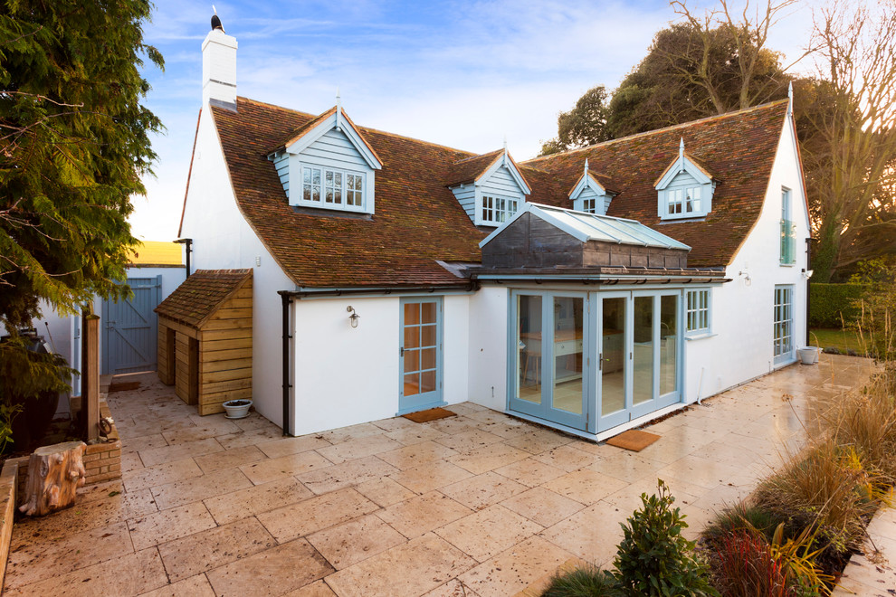 Large country two-storey stucco white exterior in Kent with a gable roof.