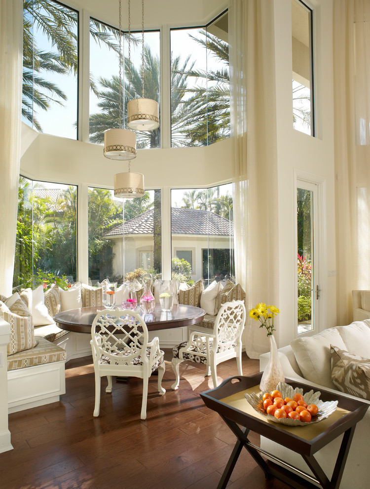 Photo of a mediterranean dining room in Miami with dark hardwood floors.