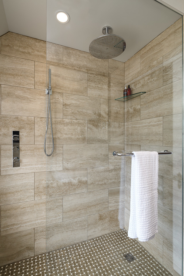 Photo of a small contemporary bathroom in Ottawa with an integrated sink, flat-panel cabinets, dark wood cabinets, a curbless shower, a wall-mount toilet, brown tile, mosaic tile, beige walls and marble floors.