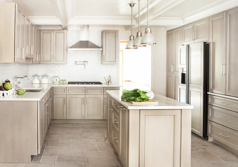 This is an example of a large transitional u-shaped kitchen in Atlanta with an undermount sink, recessed-panel cabinets, beige cabinets, white splashback, subway tile splashback, panelled appliances, with island, marble benchtops and ceramic floors.