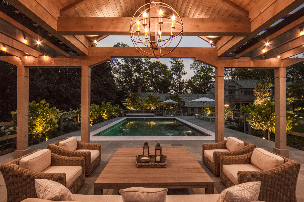 Inspiration for a mid-sized country backyard patio in New York with natural stone pavers and a gazebo/cabana.