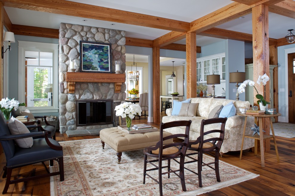Design ideas for a large country open concept living room in Grand Rapids with blue walls, a stone fireplace surround, medium hardwood floors and a standard fireplace.