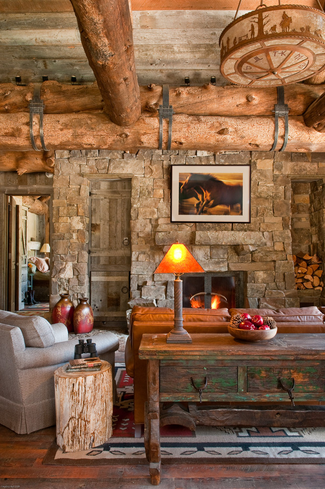 Inspiration for a country living room in Other with dark hardwood floors, a standard fireplace and a stone fireplace surround.