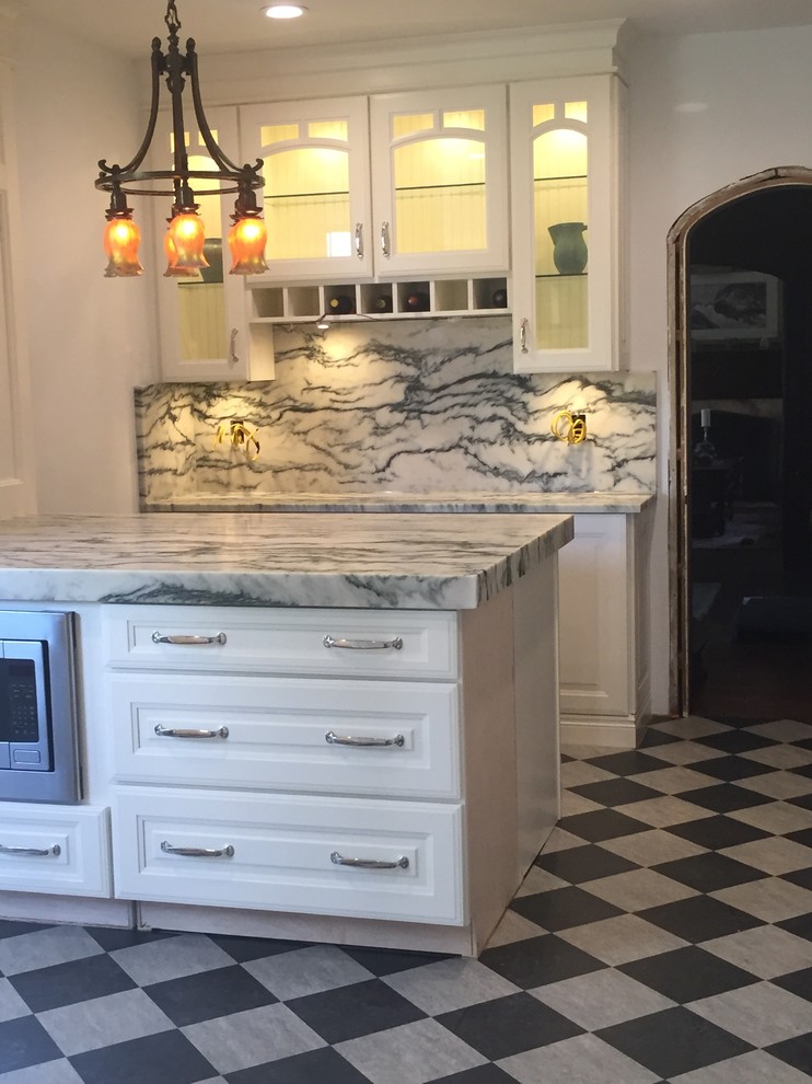Mid-sized traditional kitchen in Detroit with raised-panel cabinets, white cabinets, marble benchtops, grey splashback, stone slab splashback, stainless steel appliances, porcelain floors and with island.