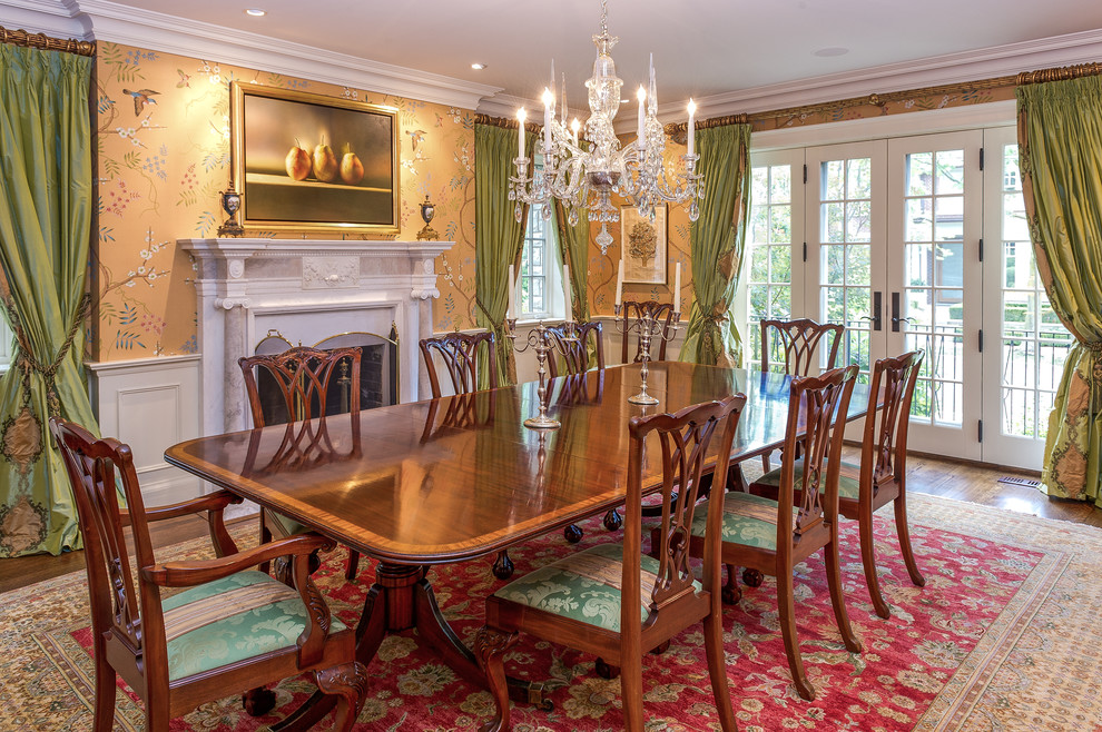 This is an example of a large traditional separate dining room in Toronto with multi-coloured walls, dark hardwood floors and a standard fireplace.