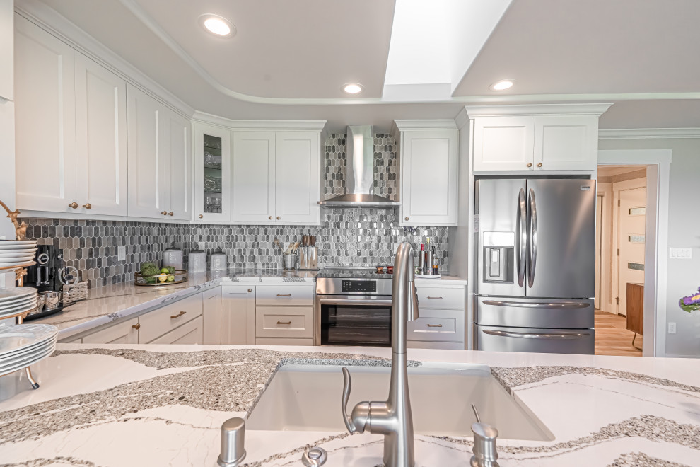 Small transitional u-shaped vinyl floor, gray floor and tray ceiling open concept kitchen photo in San Francisco with a single-bowl sink, recessed-panel cabinets, white cabinets, quartz countertops, gray backsplash, glass tile backsplash, stainless steel appliances, a peninsula and white countertops