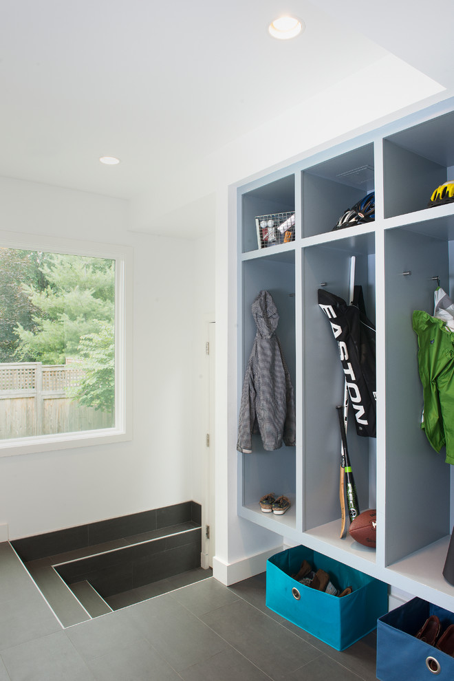 This is an example of a contemporary mudroom in Boston with grey floor.